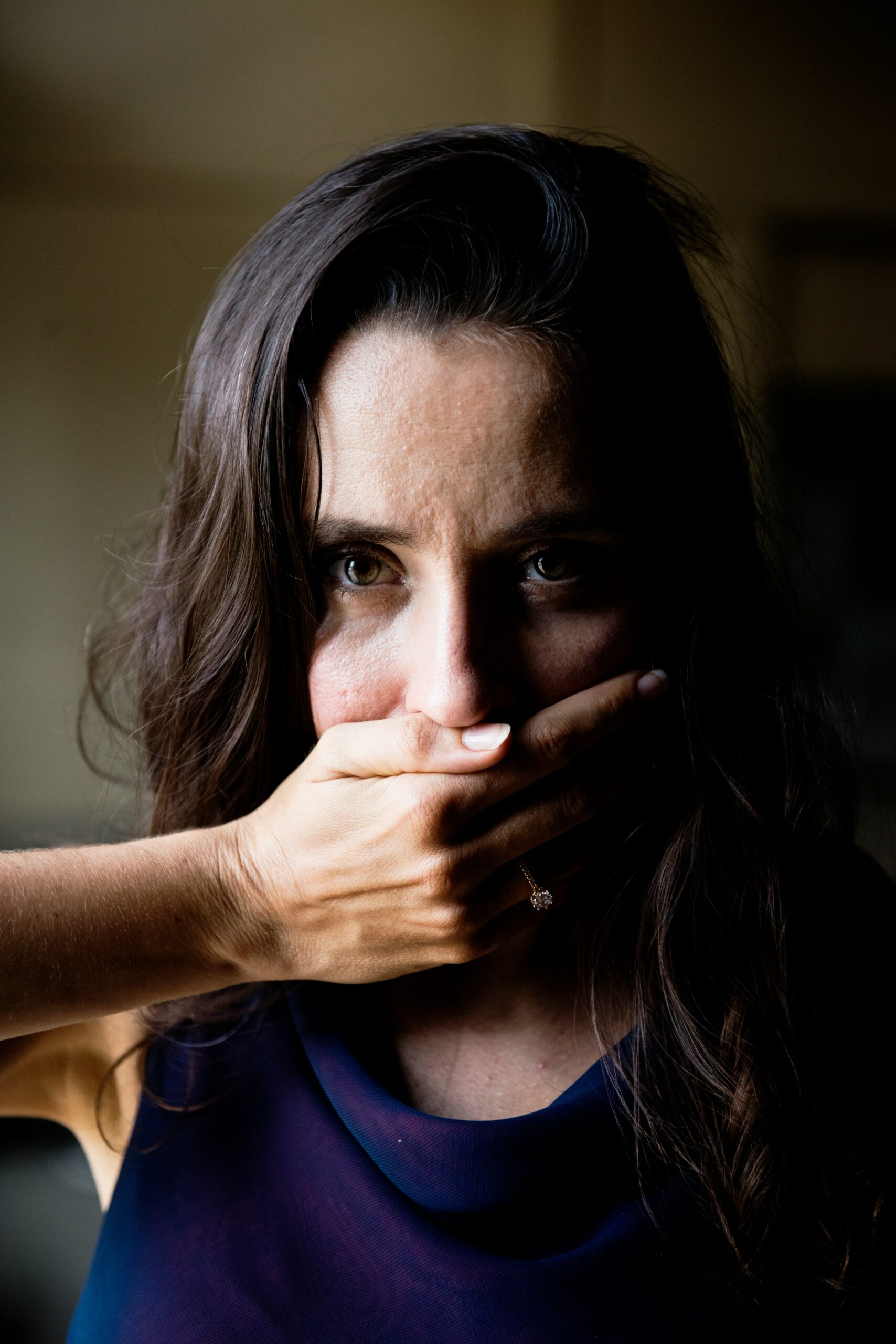 woman covering her mouth 