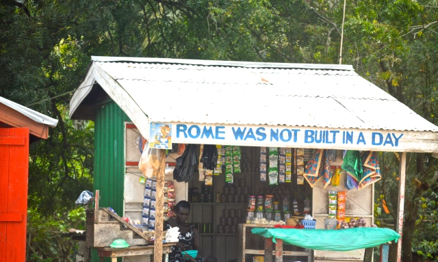 shack with bright colors and Rome Wasn't Built In A Day printed above the door.