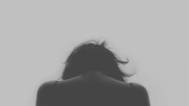 back of woman with her head bowed