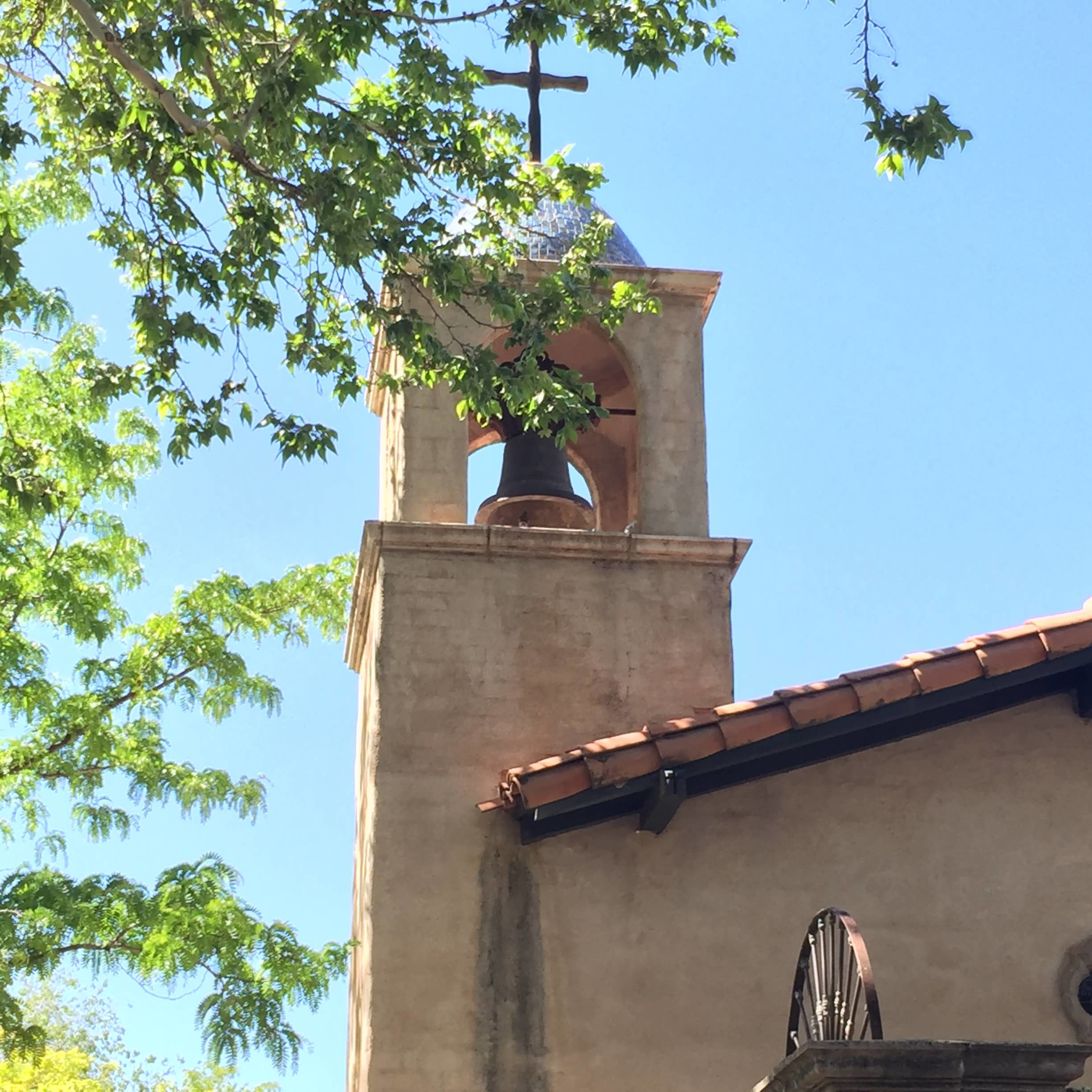 old church with bell and cross