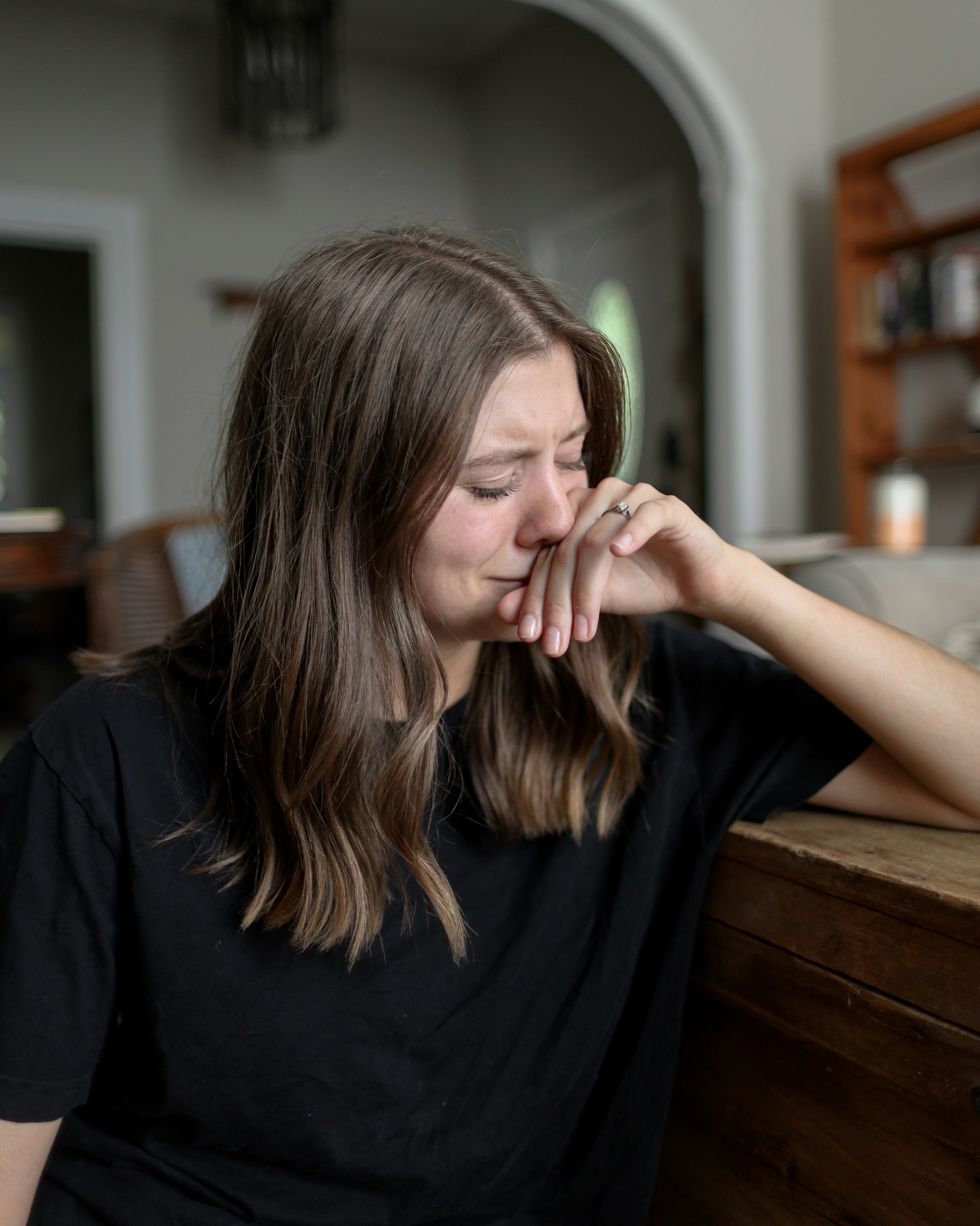 overwhelmed woman sitting at a table
